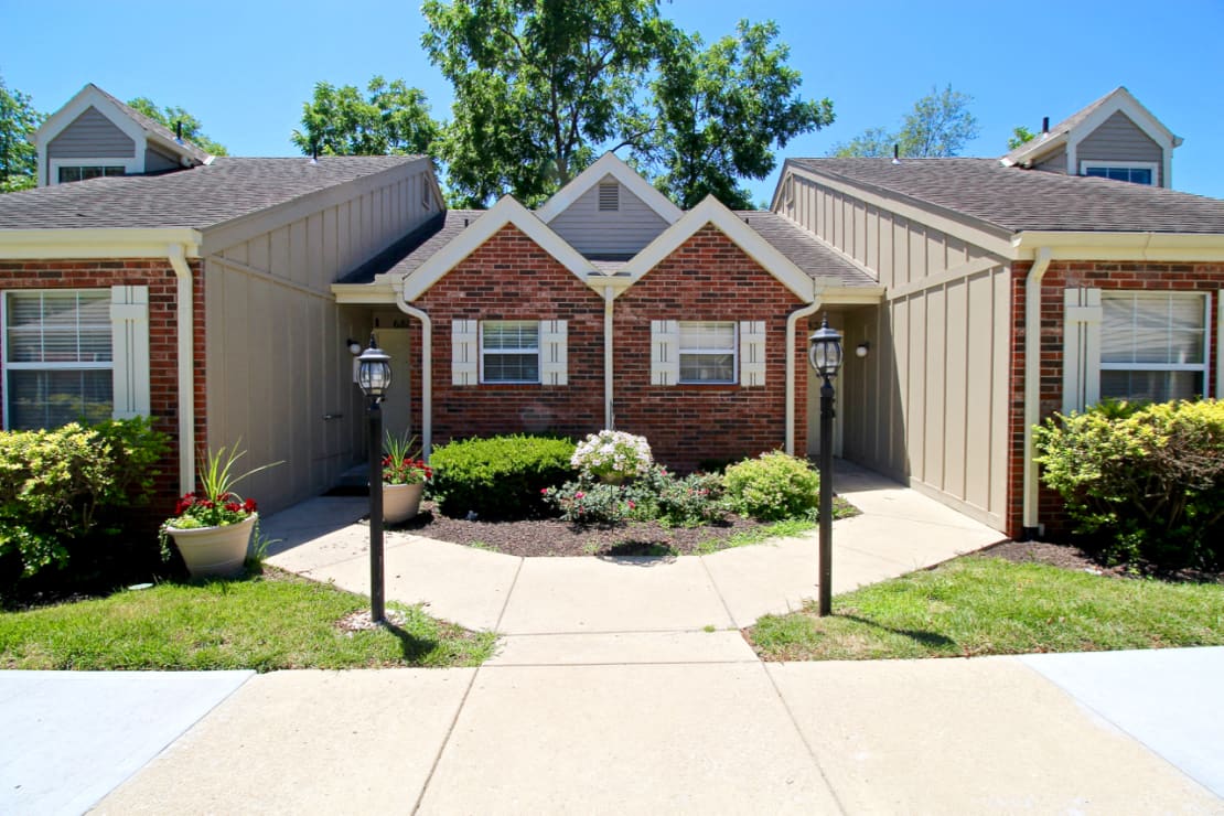 a brick house with two street lights in front of it